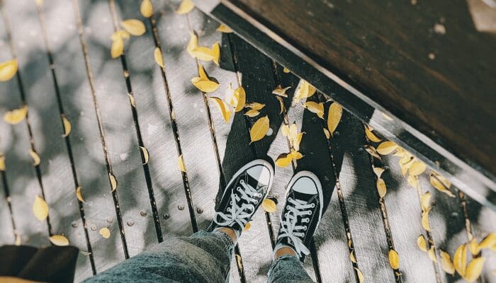A pile of leaves on a deck that needs to be removed for front yard curb appeal.